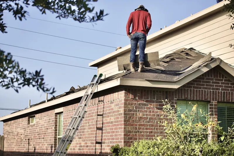 Professional roofer working on a residential roof in Hi Roc Shores